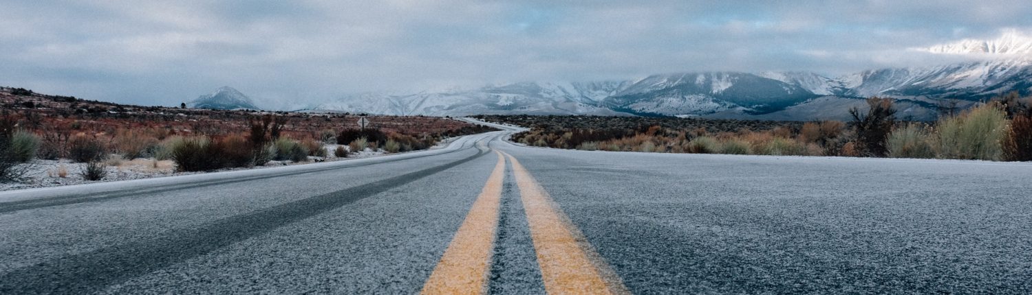 road snowy mountains cold yellow lines