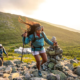 A woman and man hiking at sunset.